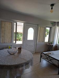 a room with a table and some windows at Family Room's Eirini in Mesolongion