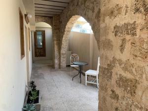 a hallway with a table and chairs in a building at Beautiful apartment & garden in Tel Aviv