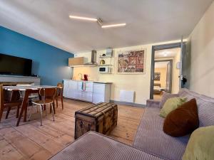 a living room with a couch and a table at A l'ombre de la Tour in Lourdes