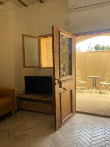 an open door leading to a patio with a table at Beautiful apartment & garden in Tel Aviv