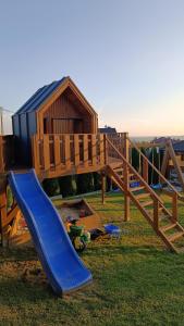 a playground with a slide and a play structure at Domki Pod Łysicą- domki z basenem in Krajno Pierwsze +41 photos
