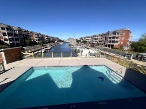 a swimming pool with a view of a river at The LOVE Boat! -An OBX Floating Getaway- in Manteo