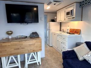a living room with a kitchen with a counter top at The LOVE Boat! -An OBX Floating Getaway- in Manteo