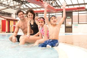 a group of people sitting in a swimming pool at Sandy Glade Holiday Park in Burnham on Sea