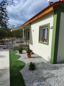 a house with a garden and a patio at Ismini's Luxury Villas in Mirodháton