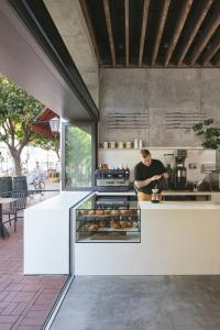 a man in a kitchen with a counter with donuts at Drift Santa Barbara, a Member of Design Hotels in Santa Barbara