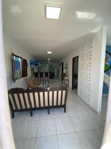 Sala de estar con 2 bancos y mesa en Siqueira Beach house, en Tamandaré