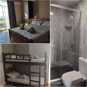 a bedroom with a bed with a shower and a toilet at TIRKIUSTAS House in K'obulet'i
