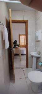 a bathroom with a toilet and a sink at Kitinet completa com varanda Praia de Caiobá in Matinhos +42 photos