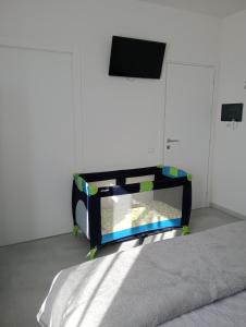 a bedroom with a bed with a tv on the wall at BnB Brotzu in Selargius