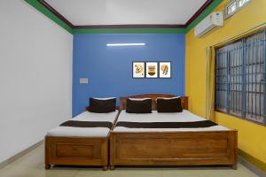 Postel nebo postele na pokoji v ubytování Hotel O Trinayani Homestay