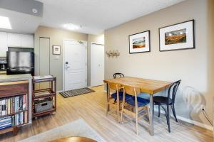a kitchen and dining room with a table and chairs at The Marquise 321 in Whistler