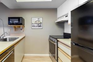a kitchen with a sink and a stove at The Marquise 321 in Whistler