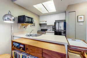 a kitchen with a sink and a refrigerator at The Marquise 321 in Whistler