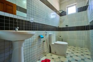 a bathroom with a sink and a toilet at Royal Suites in Mombasa