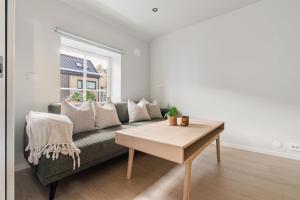 a living room with a couch and a table at Central loft apartment, with a view from the roof terrace in Tromsø