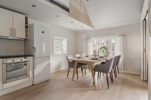 a kitchen and dining room with a table and chairs at Central loft apartment, with a view from the roof terrace in Tromsø