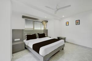 a bedroom with a large bed in a room at Hotel O Royal in Ambli Road