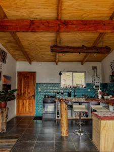 a kitchen with wooden ceilings and a counter top at refugio el bagual in Futaleufú