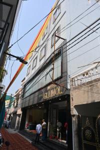 a group of people standing outside of a building at Hotel Glumol in Roorkee