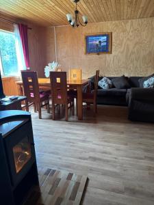 a living room with a table and a couch at "Cabaña A y M" in Chaitén