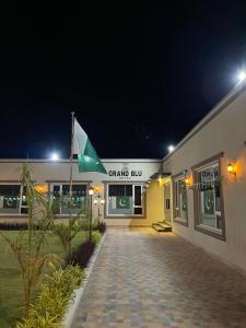 a grand run building with a flag in front of it at Grand Blu Hotel in Hyderabad