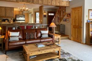 a living room with a couch and a table at Glacier B in Jackson