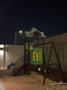 a playground in the sand at night at استراحه و مجلس مدمجه in Riyadh