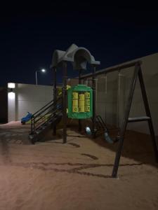 an empty playground in the sand at night at استراحه و مجلس مدمجه in Riyadh