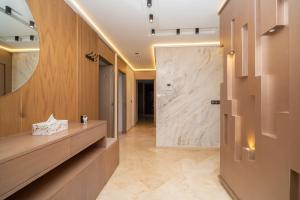 a hallway of a bathroom with a large marble wall at Luxury Apartment with Sea View & Free Parking in Tangier +77 photos