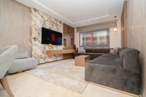 a living room with a couch and a table at Luxury Apartment with Sea View & Free Parking in Tangier
