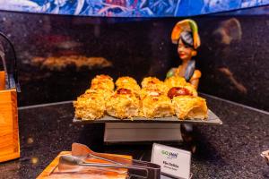 a tray of pastries on a table with a toy at Go Inn Hotel Aracaju in Aracaju