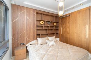 a bedroom with a large bed and wooden walls at Luxury Apartment with Sea View & Free Parking in Tangier