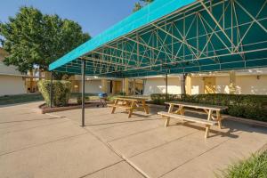 two picnic tables under awning in front of a building at Best Western Battlefield Inn in Manassas
