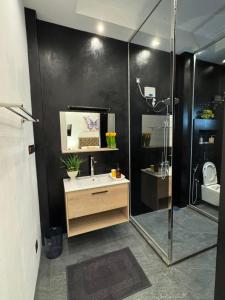 a bathroom with a sink and a shower at ThiThi's Palace Mirissa in Mirissa