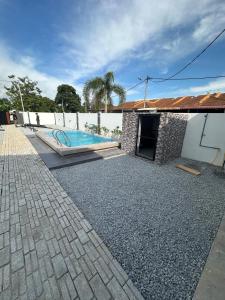 a backyard with a swimming pool and a house at Zar House With Swimming Pool in Malacca