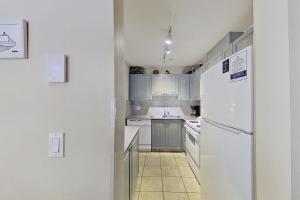 a kitchen with white appliances and a white refrigerator at The Lagoons 27 in Whistler +3 photos