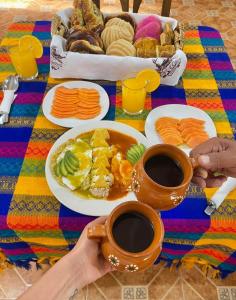 een tafel met borden en twee kopjes koffie bij Hotel Campestre El Rinconcito de Chigna in Chignahuapan