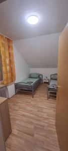 a room with two beds and a wooden floor at FeWo Spelle in Spelle