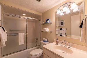 a bathroom with a shower and a toilet and a sink at Lakeside Living at Hound Ears in Valle Crucis +26 photos