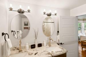 a bathroom with a sink and a mirror at Updated Downtown home next to NAU in Flagstaff
