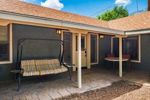 a porch with a bench and a table on a patio at Updated Downtown home next to NAU in Flagstaff