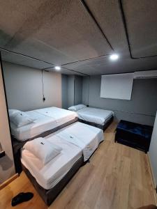 a room with three beds in a room with avertisement at Eureka Living in Bucaramanga
