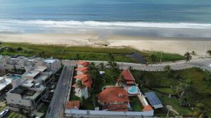 an aerial view of a beach with houses and the ocean at Pousada Água Azul in Flecheiras