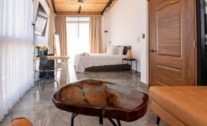 a bedroom with a bed and a table in a room at Casa Ola & Surf in San Felipe de Puerto Plata