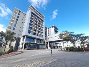 a large white building with a street in front of it at CENTURY CLUB - Luxury Apartment Hotels in Cape Town