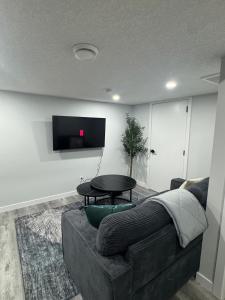 a living room with a couch and a table at Modern comfort just 20 minutes from the airport, with a full kitchen in Edmonton +16 photos