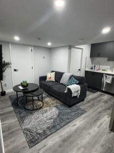 a living room with a couch and a table at Modern comfort just 20 minutes from the airport, with a full kitchen in Edmonton