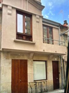 a building with two doors with graffiti on it at Ánimas, elegantes pisos en el centro histórico in Pontevedra +9 photos