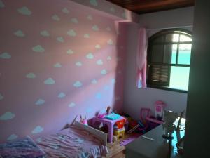 a bedroom with a purple wall with hearts on it at House available for the Rock the Mountain event in Petrópolis
